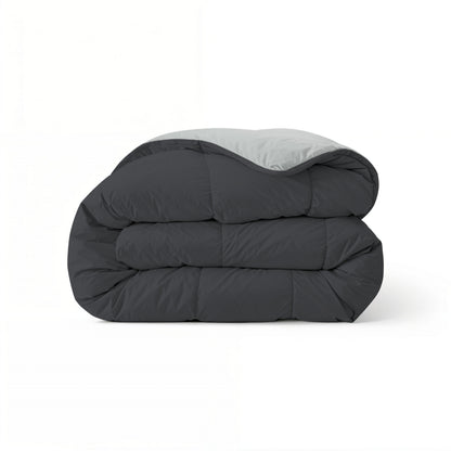 Eine sauber gefaltete Zelesta Comfort Duo Bettdecke in sanftem Schwarz & Silbergrau wird vor einem schlichten weißen Hintergrund präsentiert.