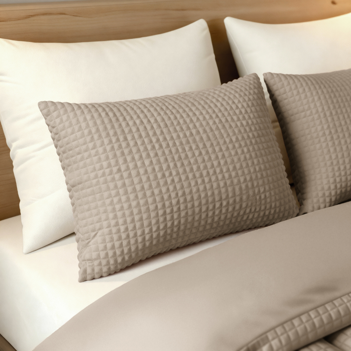 Ein hübsch gemachtes Bett mit zwei weißen 80x80cm Kissen und zwei taupefarbenen Zelesta Teddy Check Kissenbezügen, mit einer beigen Bettdecke und einem hellen Holzkopfteil. Alle Kissenbezüge sind waschbar für einfache Pflege.