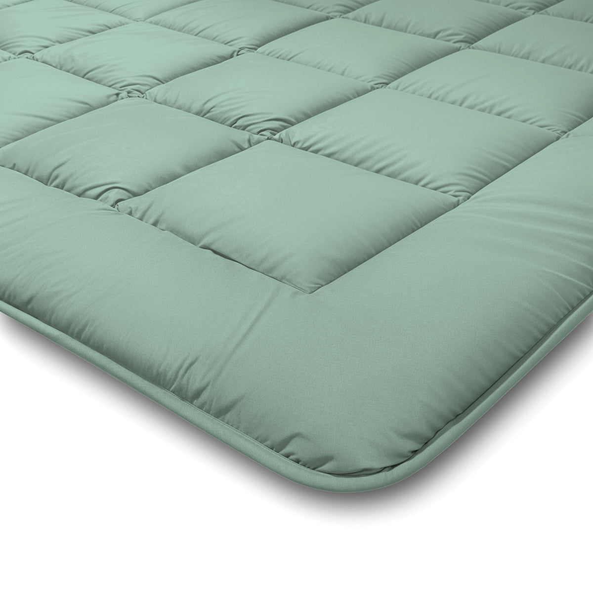 Nahaufnahme der Zelesta Comfort Duo Bettdecke in Mintgrün und Hellgrün mit quadratischen Steppnähten und gepolsterten Bereichen für mehr Komfort und Halt.