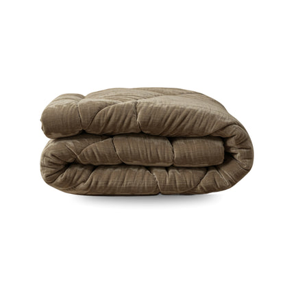 Eine gefaltete Zelesta Flanel Velvetbed Chique Bettdecke in taupe mit temperaturausgleichender Füllung ruht auf einem weißen Hintergrund.